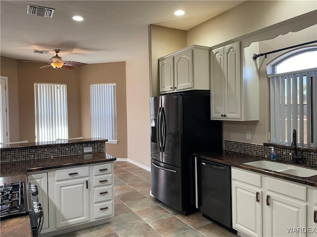 kitchen featuring a sink, visible vents, baseboards, white cabinetry, and black appliances