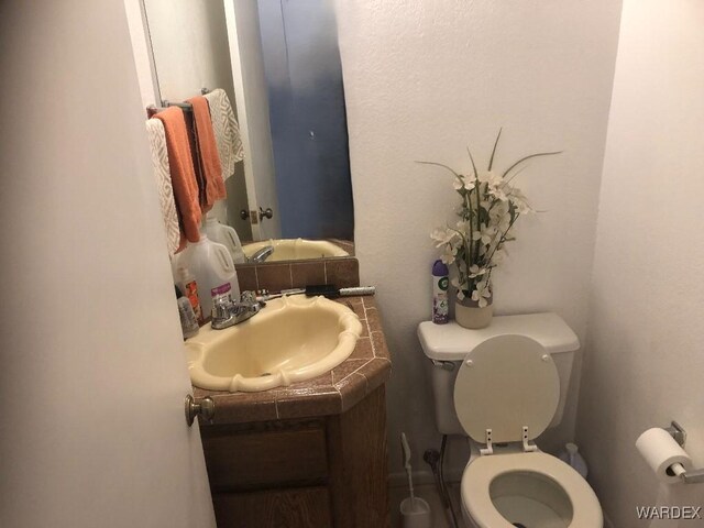 half bath with vanity and toilet