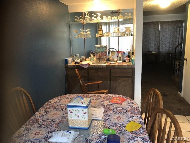 dining area featuring wet bar and tile patterned floors