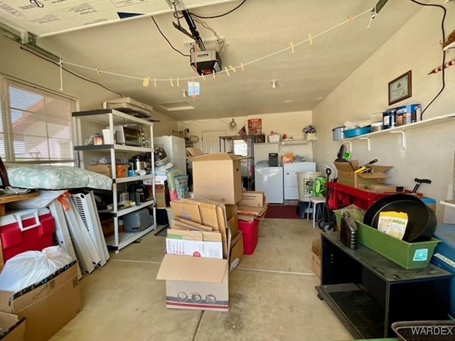 storage area featuring a garage and washing machine and clothes dryer