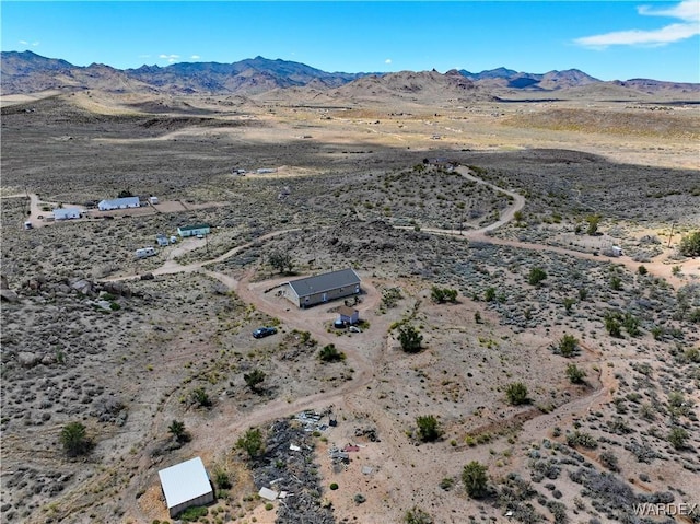 aerial view featuring a desert view and a mountain view