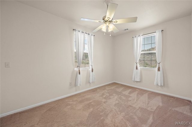 spare room featuring visible vents, ceiling fan, baseboards, and carpet