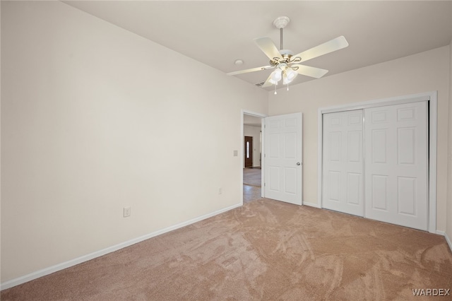 unfurnished bedroom featuring a closet, baseboards, a ceiling fan, and carpet flooring