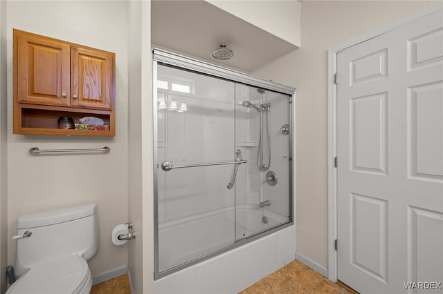 bathroom with enclosed tub / shower combo, tile patterned floors, toilet, and baseboards