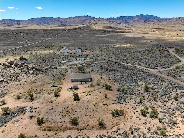 birds eye view of property featuring a mountain view and a desert view