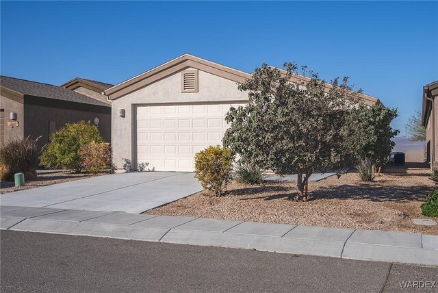 view of front of house featuring a garage, driveway, and stucco siding