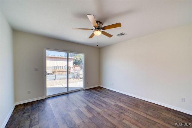 empty room featuring visible vents, dark wood finished floors, baseboards, and ceiling fan