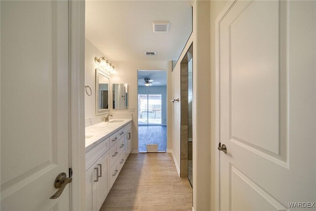 bathroom featuring visible vents, a sink, and double vanity