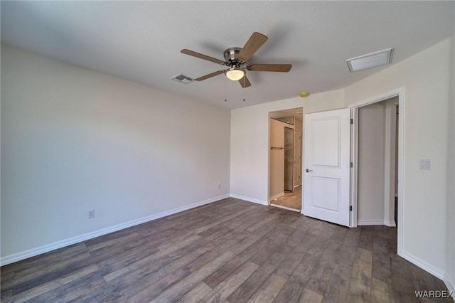 unfurnished bedroom with dark wood-style floors, visible vents, ceiling fan, and baseboards