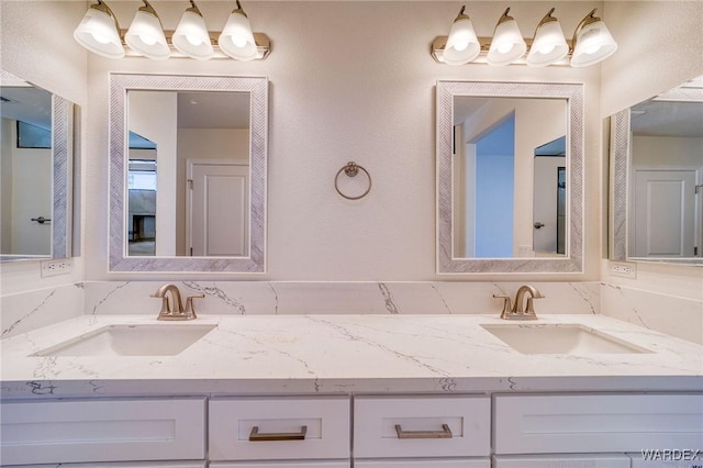 full bathroom featuring a sink and double vanity