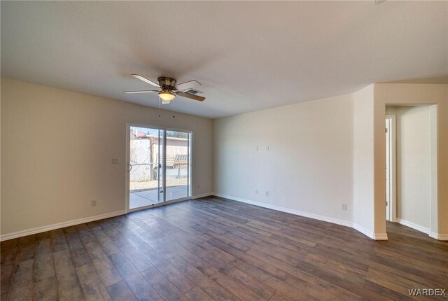 unfurnished room with baseboards, a ceiling fan, and dark wood-type flooring