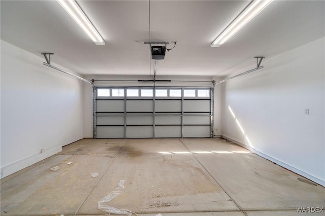 garage with a garage door opener and baseboards