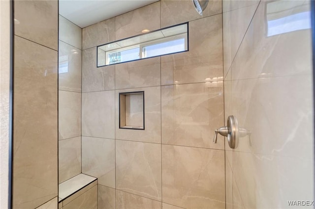 bathroom with tiled shower