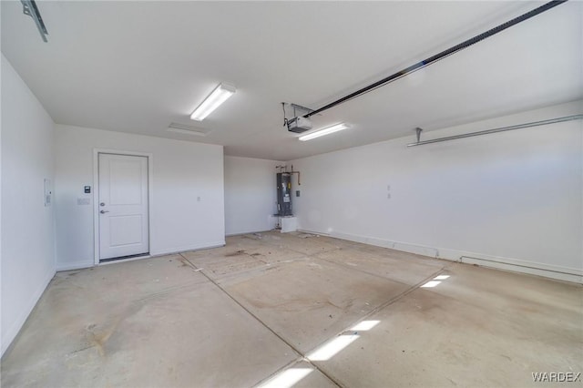 garage with water heater and a garage door opener