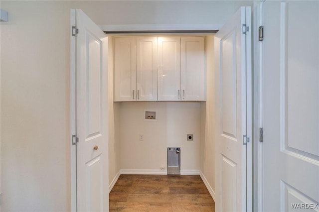 washroom featuring washer hookup, cabinet space, electric dryer hookup, wood finished floors, and baseboards