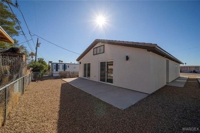 back of property featuring a patio, fence, and stucco siding