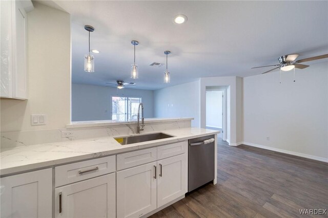 kitchen with a sink, a peninsula, white cabinets, and stainless steel dishwasher