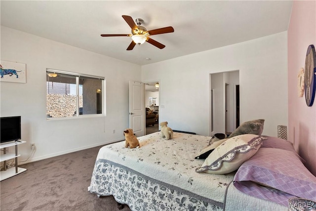 carpeted bedroom with ceiling fan and baseboards