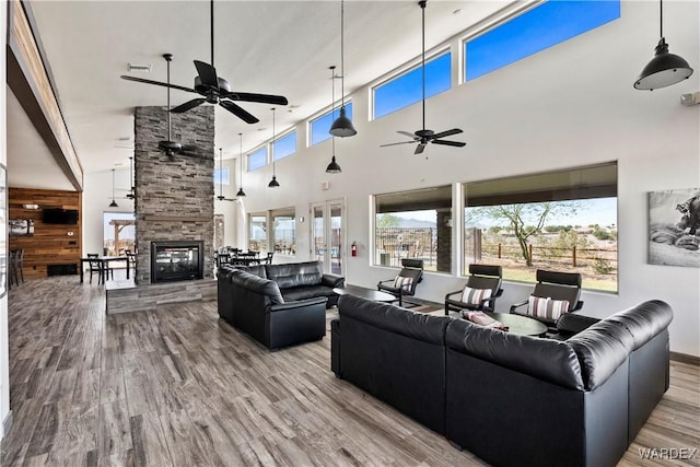 2499 Sonoma Rd, Bullhead City, AZ 86442 - living area with light wood-type flooring, a fireplace, visible vents, and a ceiling fan