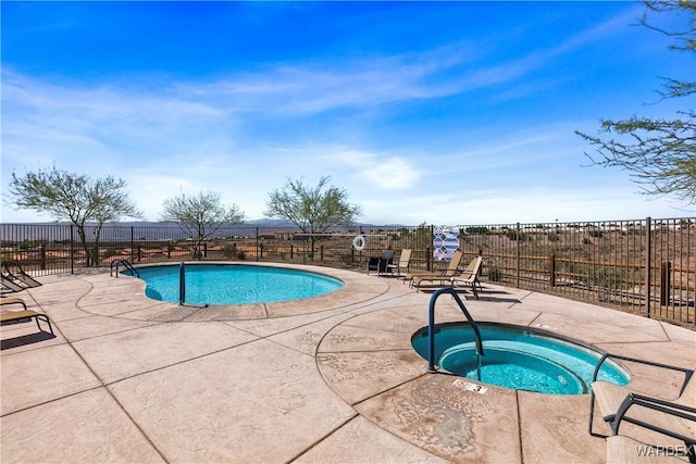 pool featuring fence, a community hot tub, and a patio