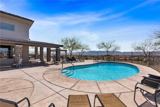 community pool with a patio and fence