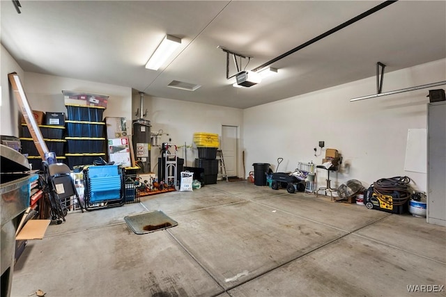 garage with a garage door opener and gas water heater