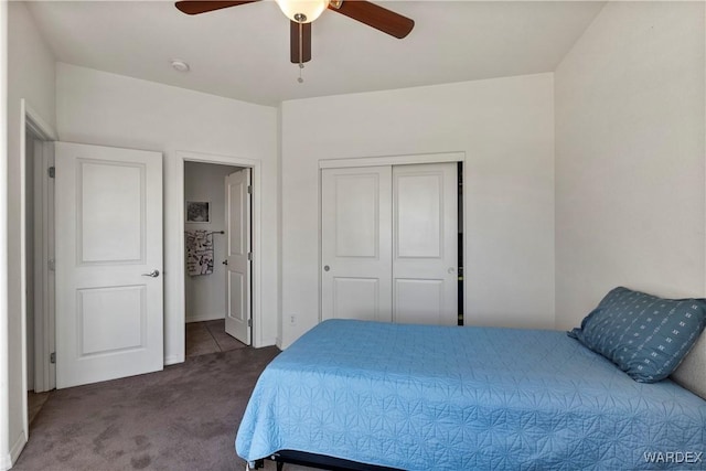 carpeted bedroom featuring a ceiling fan and a closet