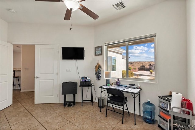 office with visible vents, ceiling fan, baseboards, and light tile patterned floors