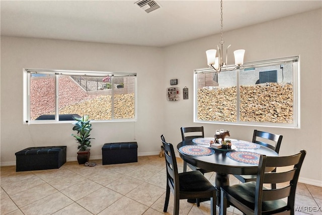 dining space featuring light tile patterned floors, visible vents, baseboards, and an inviting chandelier