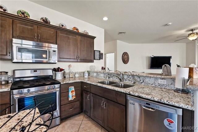 2499 Sonoma Rd, Bullhead City, AZ 86442 - kitchen with light stone counters, light tile patterned flooring, a sink, visible vents, and appliances with stainless steel finishes