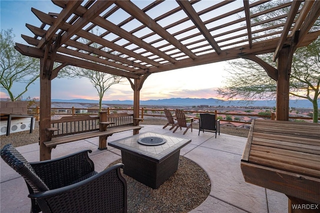 view of patio with an outdoor fire pit, a mountain view, and a pergola