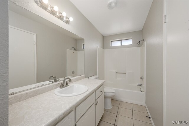 full bathroom with toilet, tub / shower combination, vanity, baseboards, and tile patterned floors