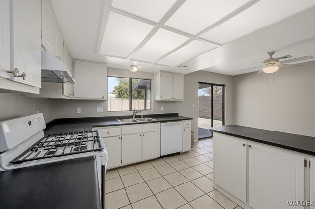 kitchen featuring white appliances, white cabinets, and a sink