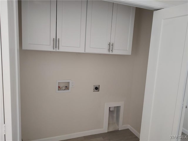 laundry area featuring cabinet space, baseboards, dark wood finished floors, washer hookup, and electric dryer hookup