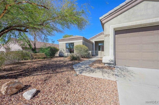 view of front of home featuring a garage and stucco siding