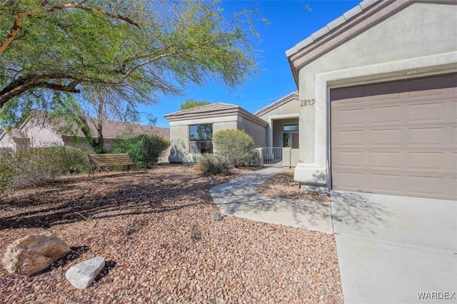 view of front of house with an attached garage and stucco siding