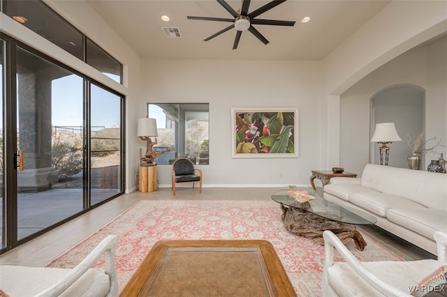 living area with recessed lighting, visible vents, baseboards, and light tile patterned floors