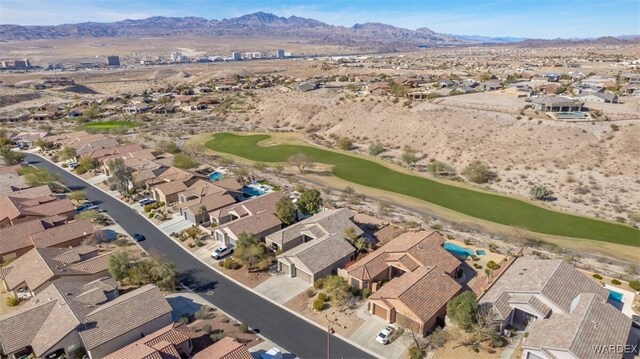 aerial view featuring a residential view, a mountain view, and golf course view