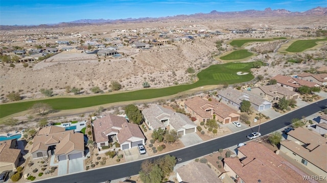 aerial view with a residential view, a mountain view, and golf course view