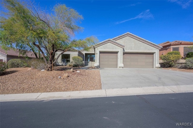 ranch-style home featuring an attached garage, driveway, and stucco siding