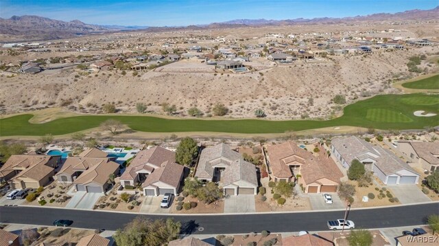 aerial view featuring a residential view, a mountain view, and golf course view