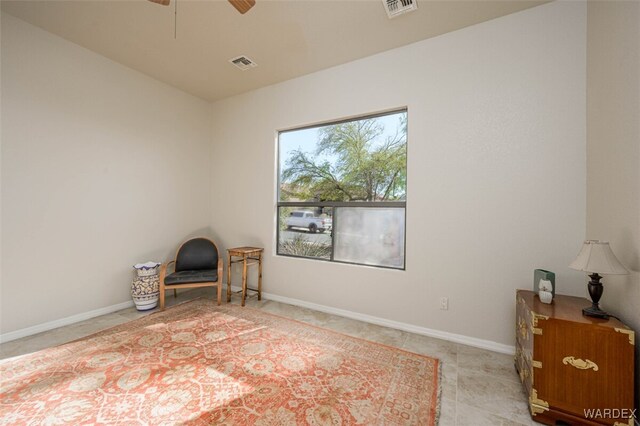 unfurnished room with baseboards, visible vents, and a ceiling fan