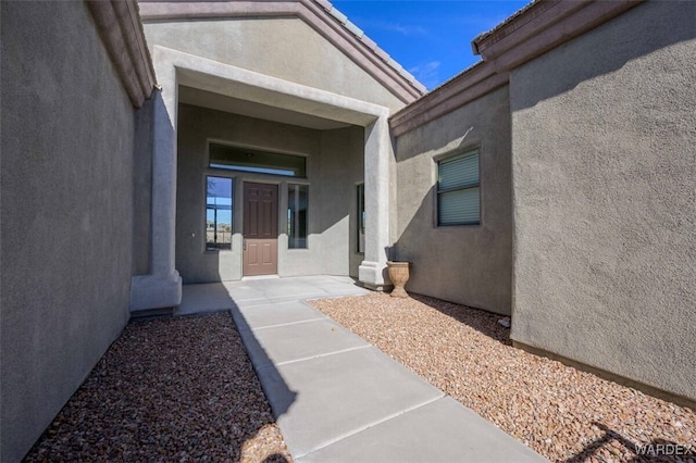 property entrance featuring stucco siding