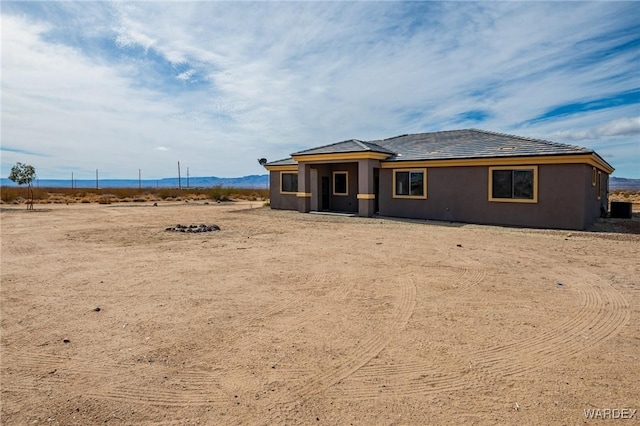 view of front of property featuring central air condition unit and stucco siding