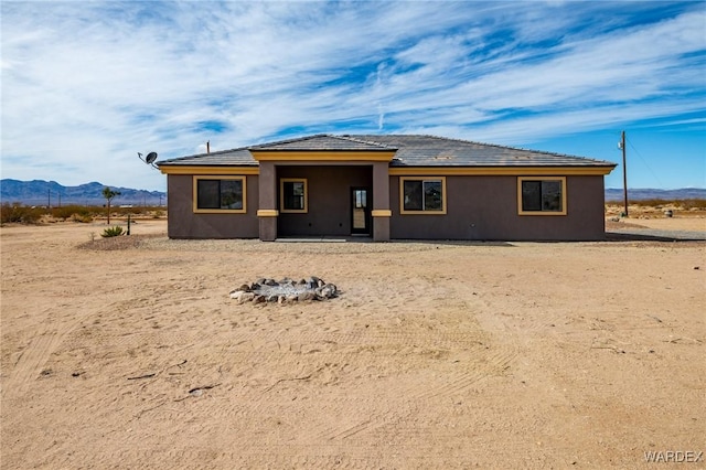 view of front of house with a mountain view and stucco siding