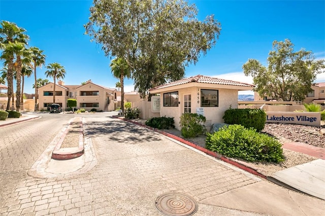 1650 Smoketree Ave Unit 103, Lake Havasu, AZ 86403 - view of front of property with stucco siding, a tiled roof, and a residential view