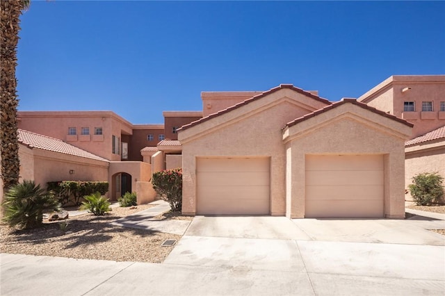 1650 Smoketree Ave Unit 103, Lake Havasu, AZ 86403 - southwest-style home featuring driveway, an attached garage, stucco siding, and a tiled roof