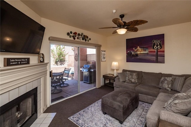 1650 Smoketree Ave Unit 103, Lake Havasu, AZ 86403 - living room featuring carpet floors, a tiled fireplace, and a ceiling fan
