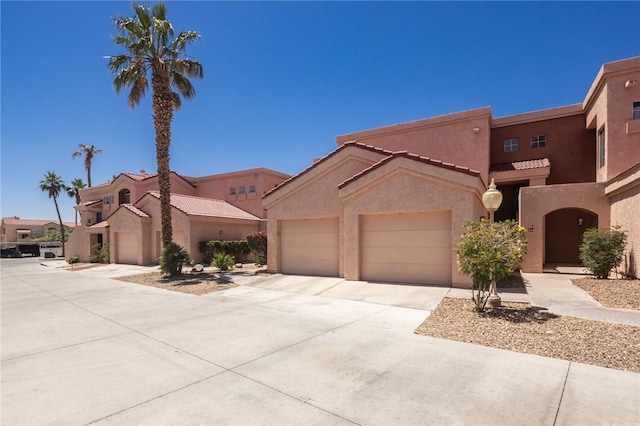 1650 Smoketree Ave Unit 103, Lake Havasu, AZ 86403 - view of front of property featuring stucco siding, concrete driveway, an attached garage, and a tile roof