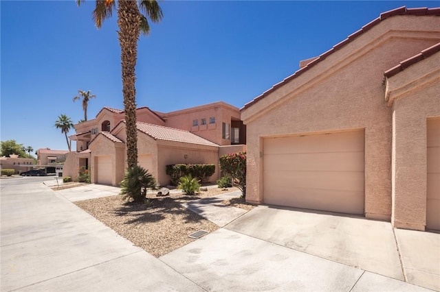 1650 Smoketree Ave Unit 103, Lake Havasu, AZ 86403 - view of front of home with stucco siding, concrete driveway, and a tiled roof
